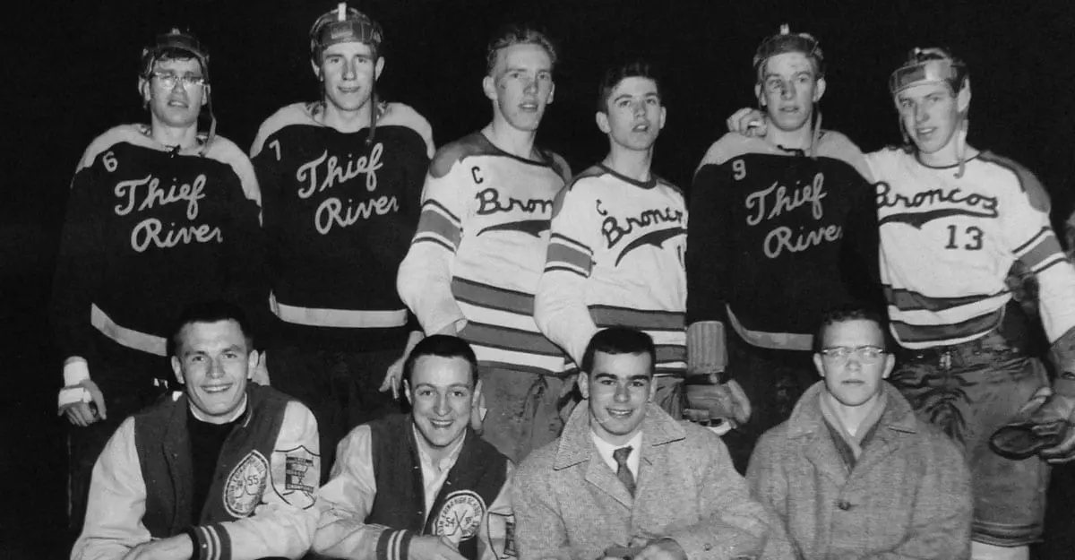 A group of men in hockey uniforms posing for a picture.