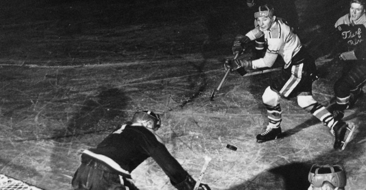 A man in black and white playing hockey.