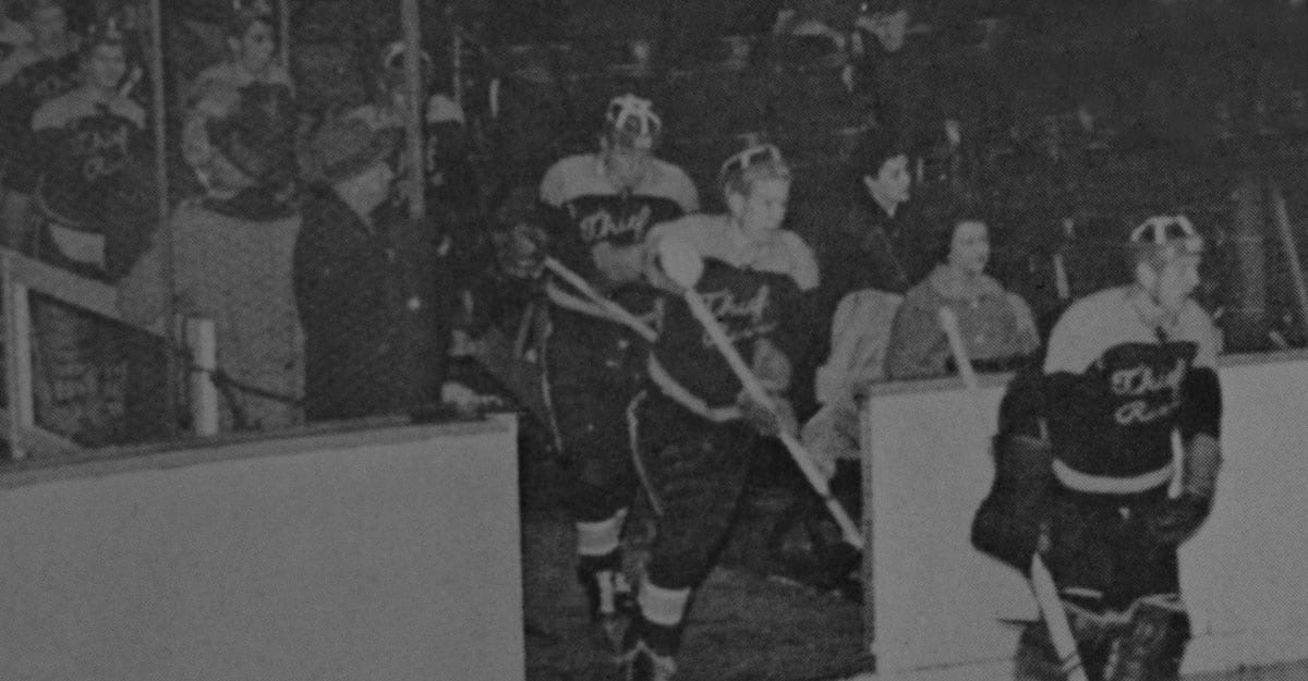 A hockey player is walking on the ice.