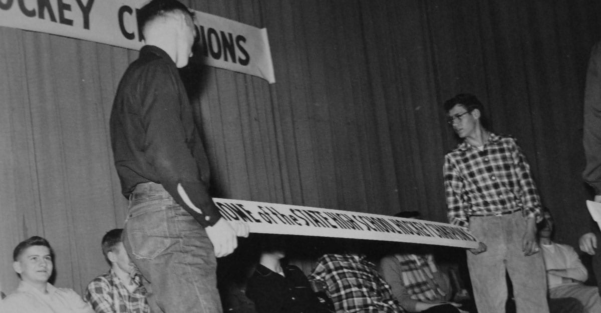 A man standing in front of a crowd holding a keyboard.