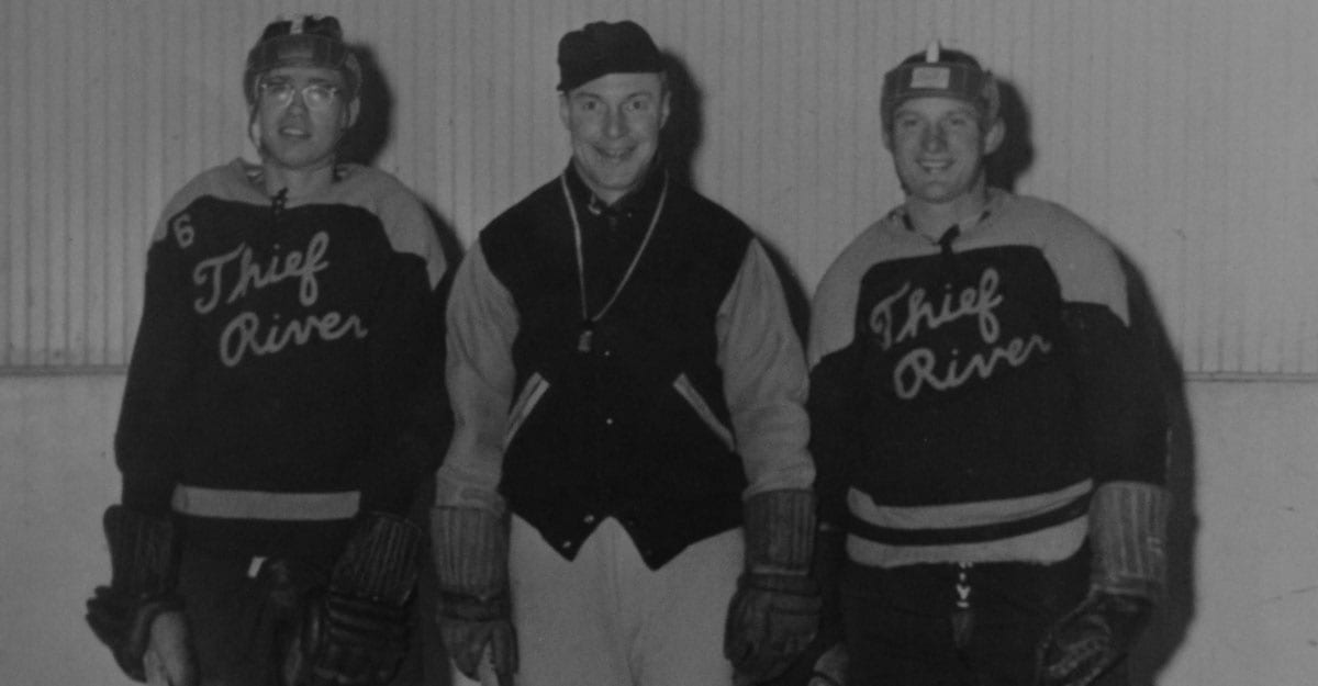 Three men in baseball uniforms are posing for a picture.