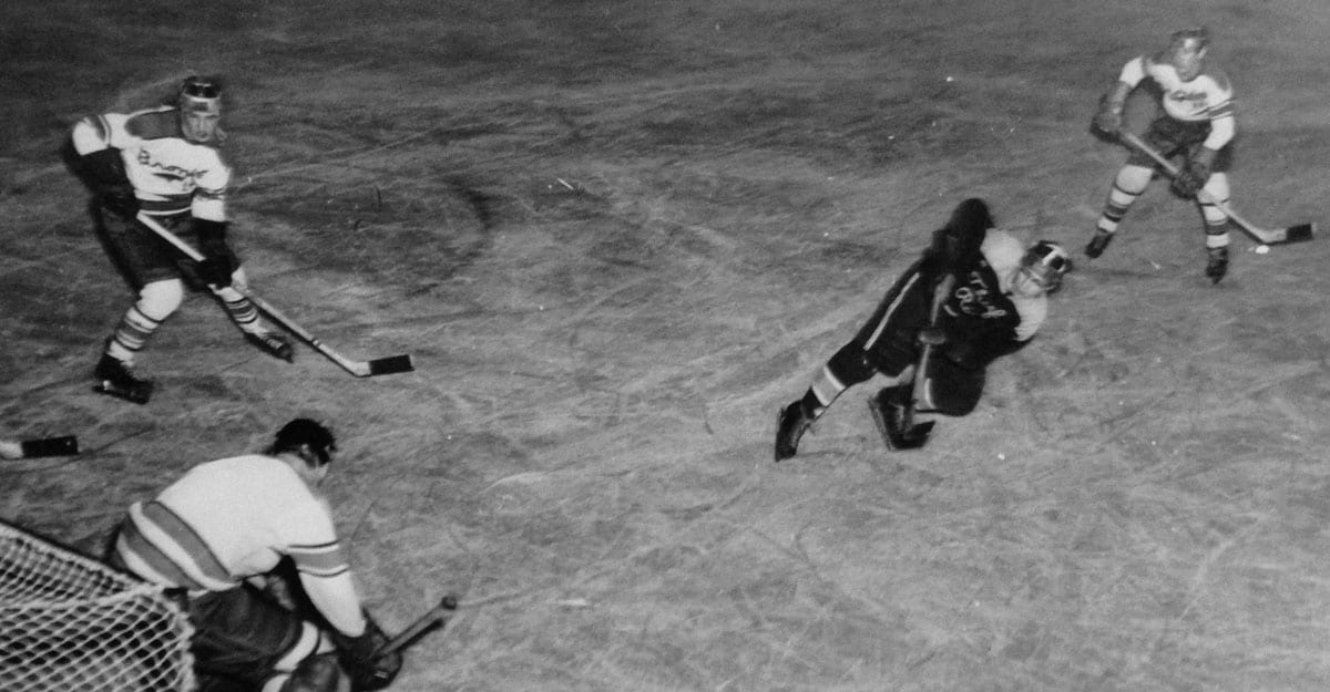 A black and white photo of two men playing baseball.