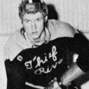 A man in hockey uniform holding a stick.