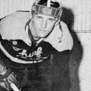 A hockey player in the 1 9 5 0 's wearing a helmet.