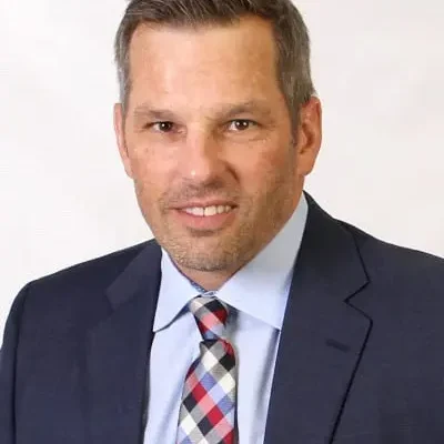 A man in a suit and tie standing up.